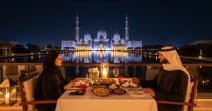 Outdoor Suhoor dining experience at Al Qana Waterfront with the illuminated Sheikh Zayed Grand Mosque in the background during Abu Dhabi City Tour in Ramadan 2026